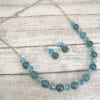 necklace with blue stones and crystals on a wooden surface
