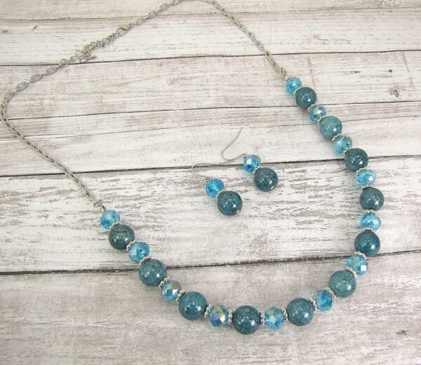 necklace with blue stones and crystals on a wooden surface