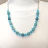 necklace with blue stones and crystals on a mannequin