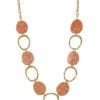 golden necklace with large hoops and pink flat beads
