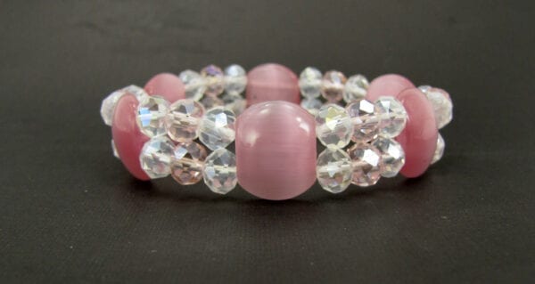 bracelet with pink stones and crystals on a black surface