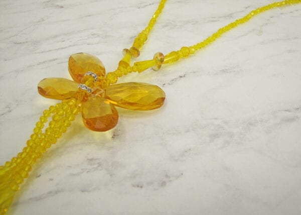 Close up of Necklace with yellow crystals in a butterfly design