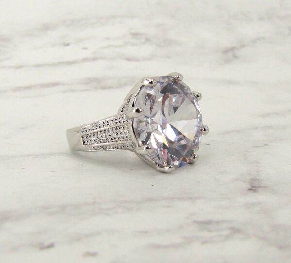 large diamond ring on a marble surface