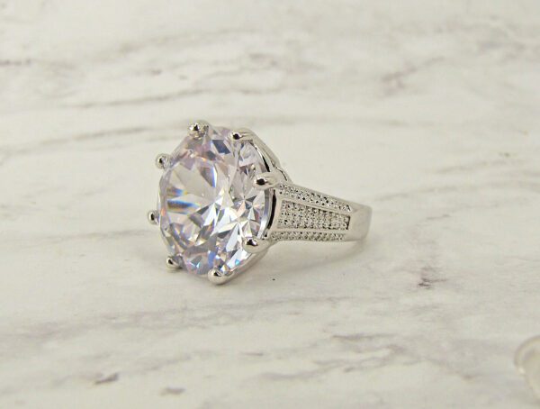 large diamond ring on a marble surface