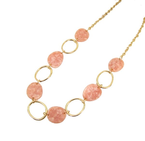 golden necklace with large metal hoops and pink beads