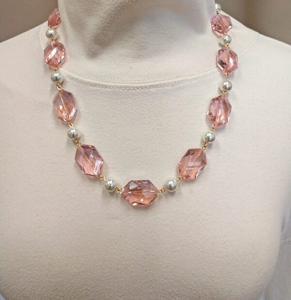 necklace with large, pink crystal gems on a mannequin