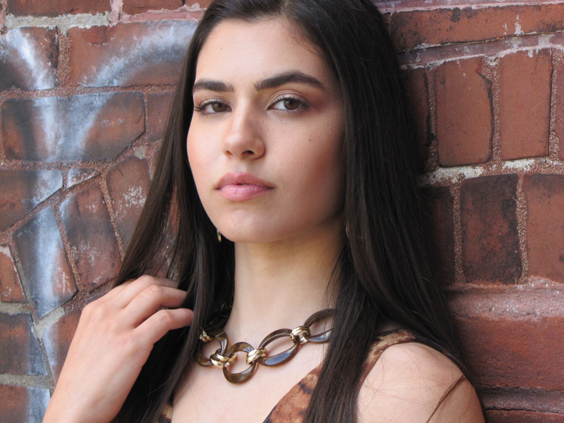 A women with black hair wearing a necklace