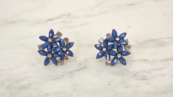 A pair of blue colored crystal flower earrings