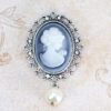 Brooch With a Woman White Figure With a Pearl One