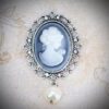 A Brooch With a Woman White Figure With a Pearl