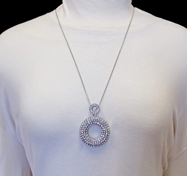 A Person With Large Round Clear Crystals Pendant Necklace