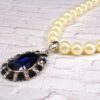 WHITE PEARL NECKLACE WITH BLUE CRYSTAL TEARDROP PENDANT - Image 2